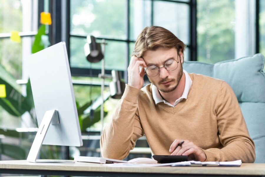 Pensive man, struggling with debt and considering debt consolidation