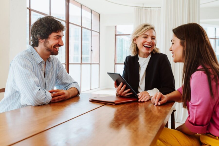 Mortgage broker and clients talking about how federal Budget 2025-2026 affects home buyers