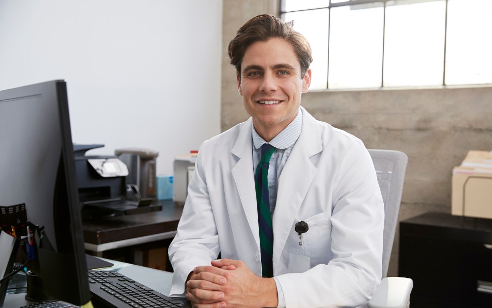 Smiling young male doctor who knows about home loans for medical professionals