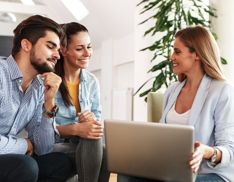 Female mortgage broker and a couple talking about interest rate vs comparison rate