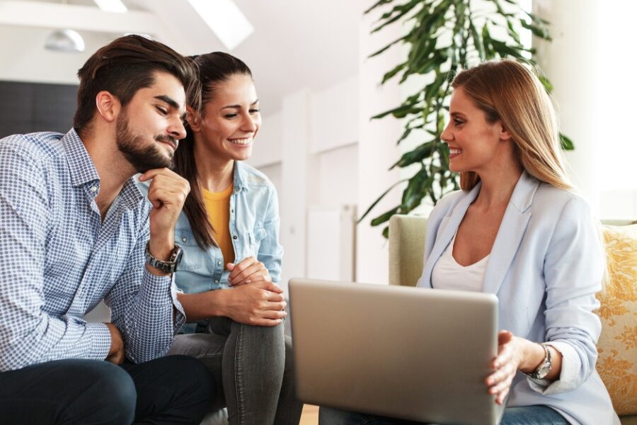 Female mortgage broker and a couple talking about interest rate vs comparison rate