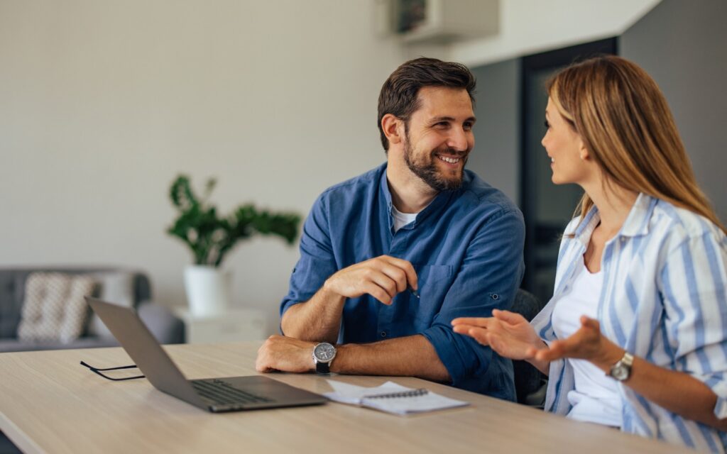 Couple talking about home loans while researching interest rate cuts
