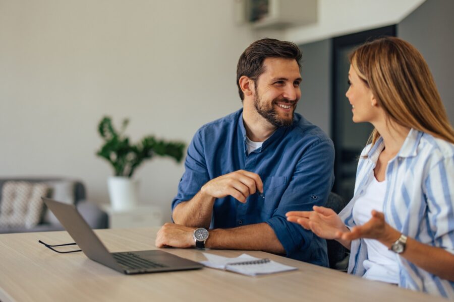 Couple talking about home loans while researching interest rate cuts