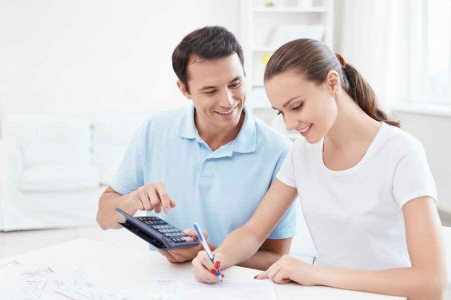Couple calculating expenses and considering extra repayments